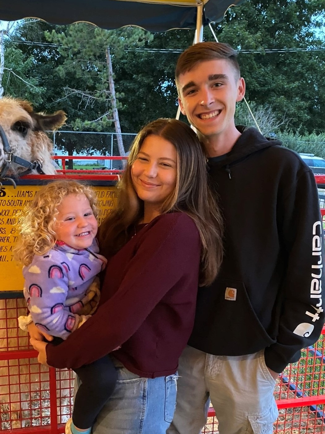 A picture of Aaron and his girlfriend Taylor and her little sister Ella at the fair.